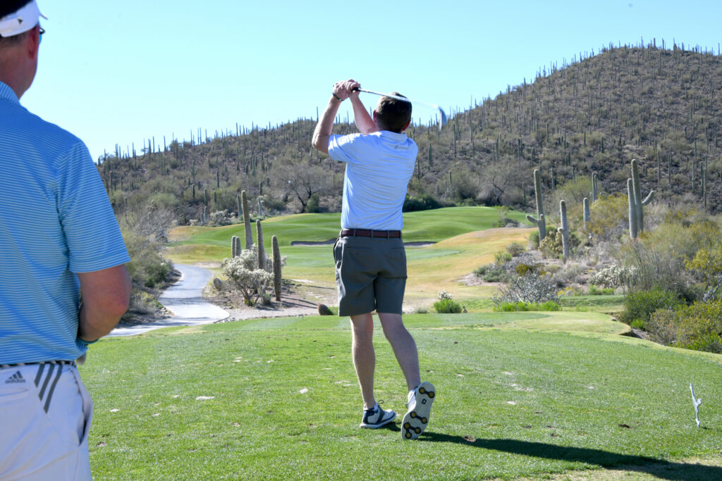 Golfer on the tee box on a desert golf course.
