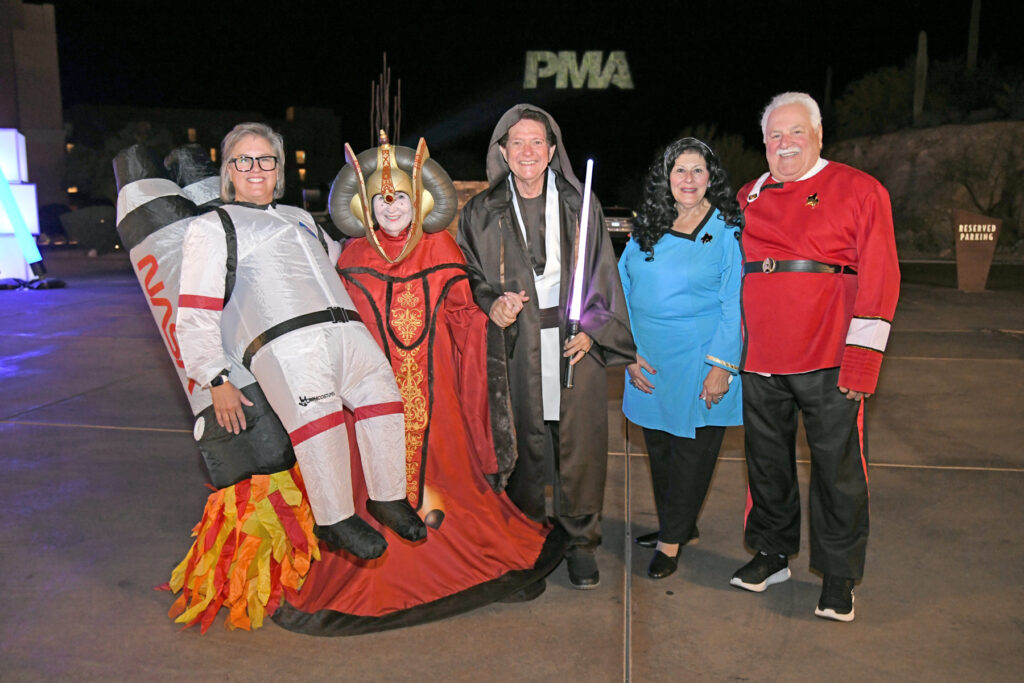 Group of people dressed up in space themed outfits.